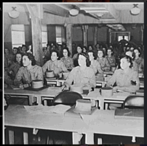 Women's Army Auxiliary Corps in a classroom after their march drill. Iowa, 1942